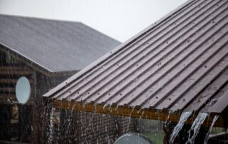 Metal roofing in heavy Florida rain showing water runoff and durability, illustrating best roofing materials for Florida homes in storms and extreme weather, Castaways Roofing