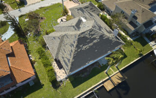 Florida roof heat damage with worn shingles on residential home aerial view, showing sun exposure impact and need for roof protection and replacement, Castaways Roofing