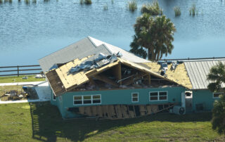 Severe hurricane damage to Florida home with roof collapse and structural failure, highlighting importance of roof preparation and storm readiness, Castaways Roofing