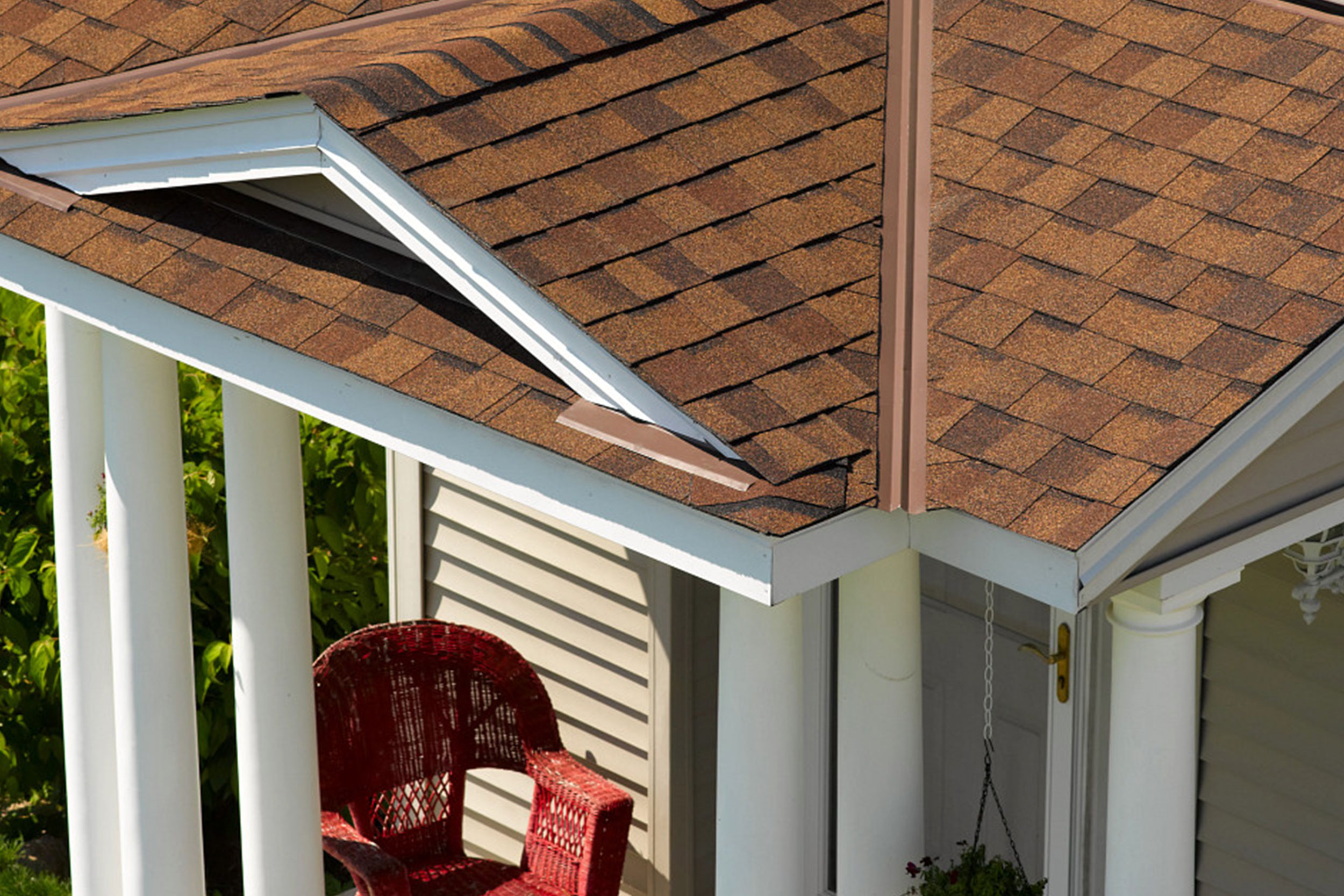 Close-up of architectural asphalt shingle roof with ridge cap and gable detail on residential home, showcasing durable weather-resistant roofing installation by Castaways Roofing